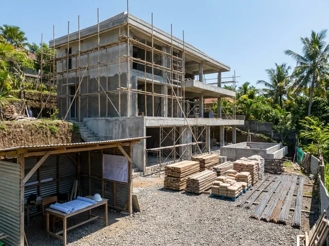 Site manager supervising villa construction quality on a Bali building site