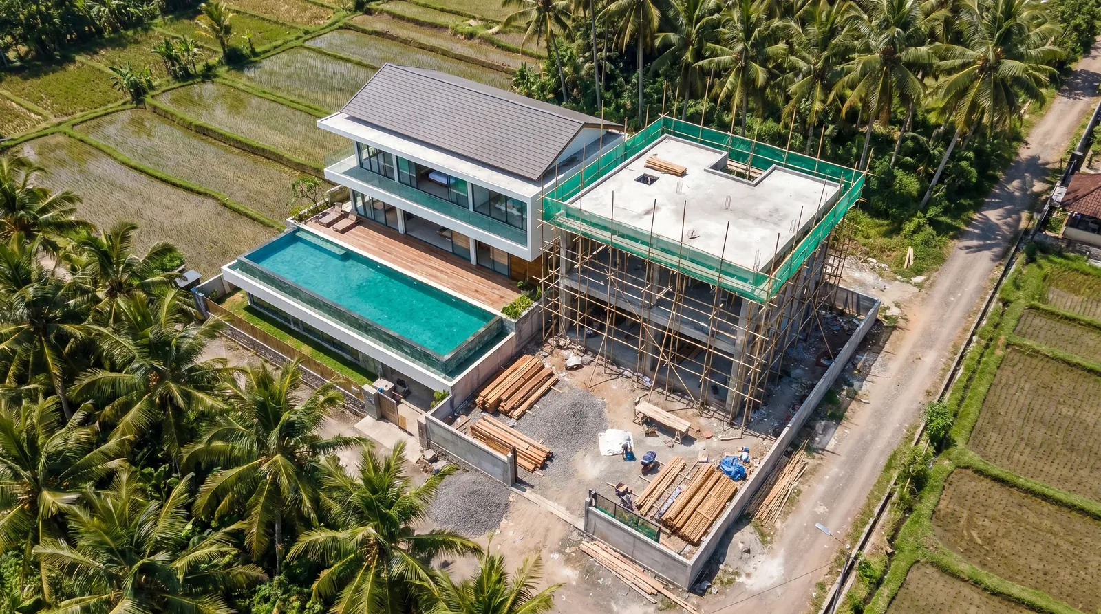 Aerial view of Bali coastline with pool villas and tropical landscape